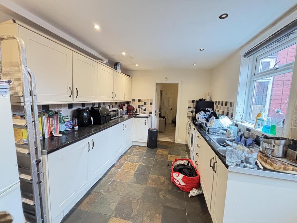 A bright and spacious kitchen area with ample c...