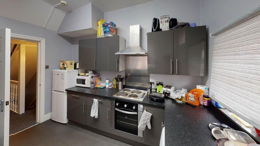 A well-equipped kitchen featuring modern applia...
