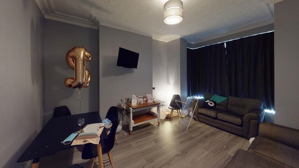 A spacious and well-lit living room featuring m...
