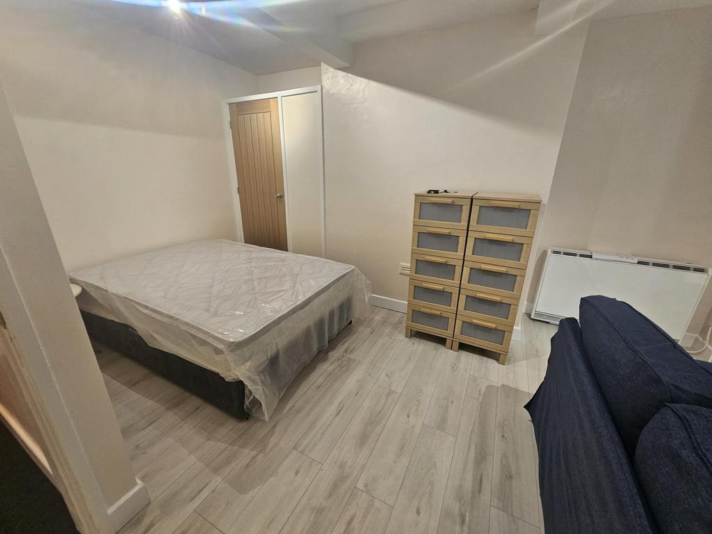 A clean and simple double bedroom featuring a d...