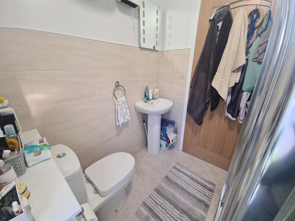 Well-maintained bathroom featuring a toilet, pe...