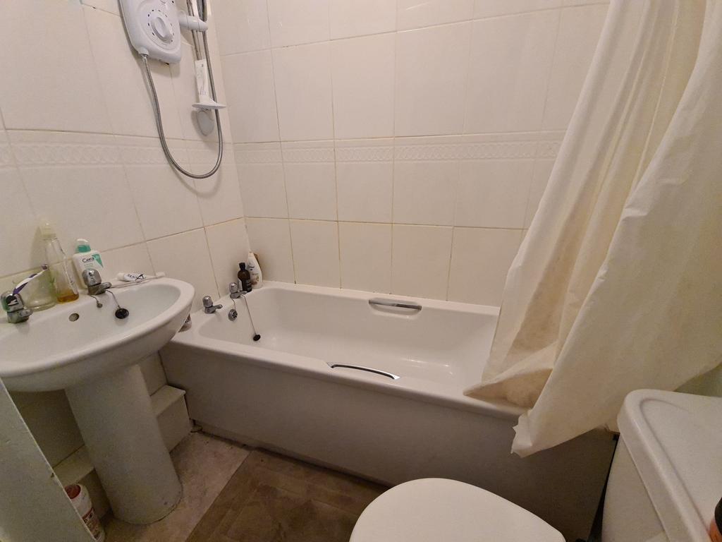 Well-maintained bathroom with a bathtub and sho...
