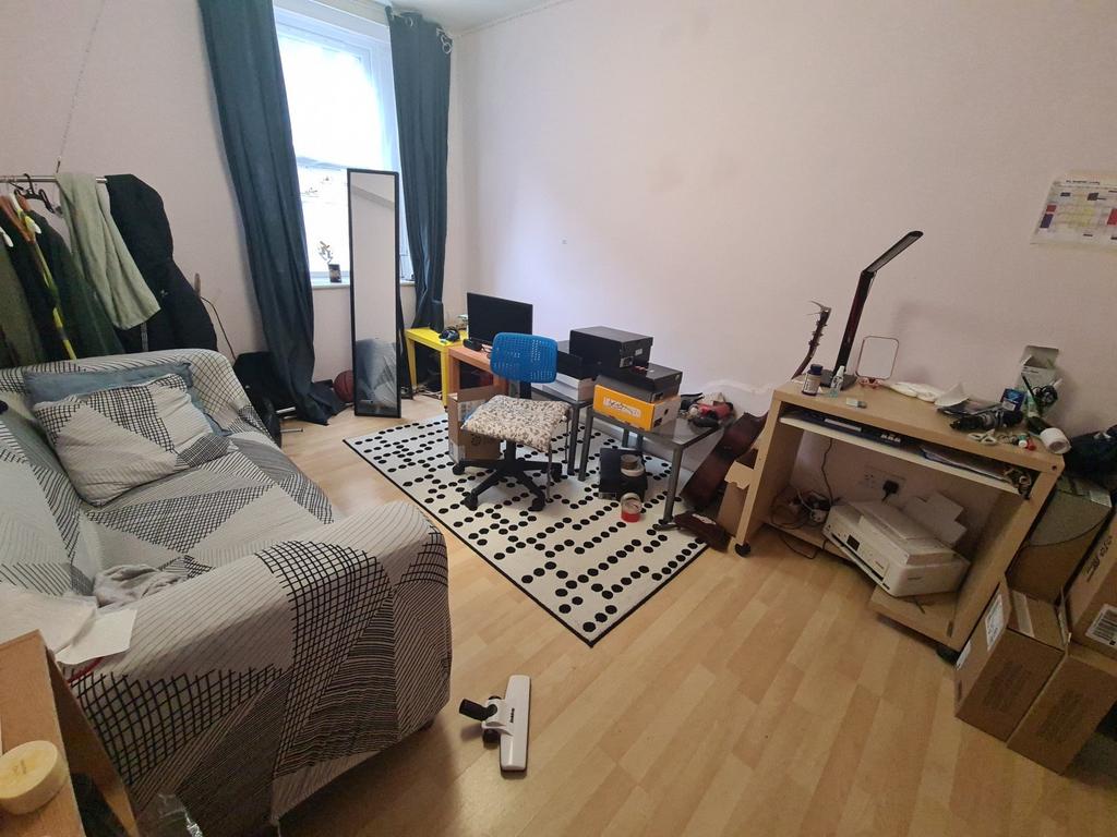 Cozy furnished bedroom with a single bed, study...