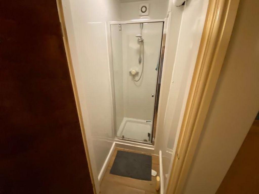 Compact and clean single toilet room with a mod...