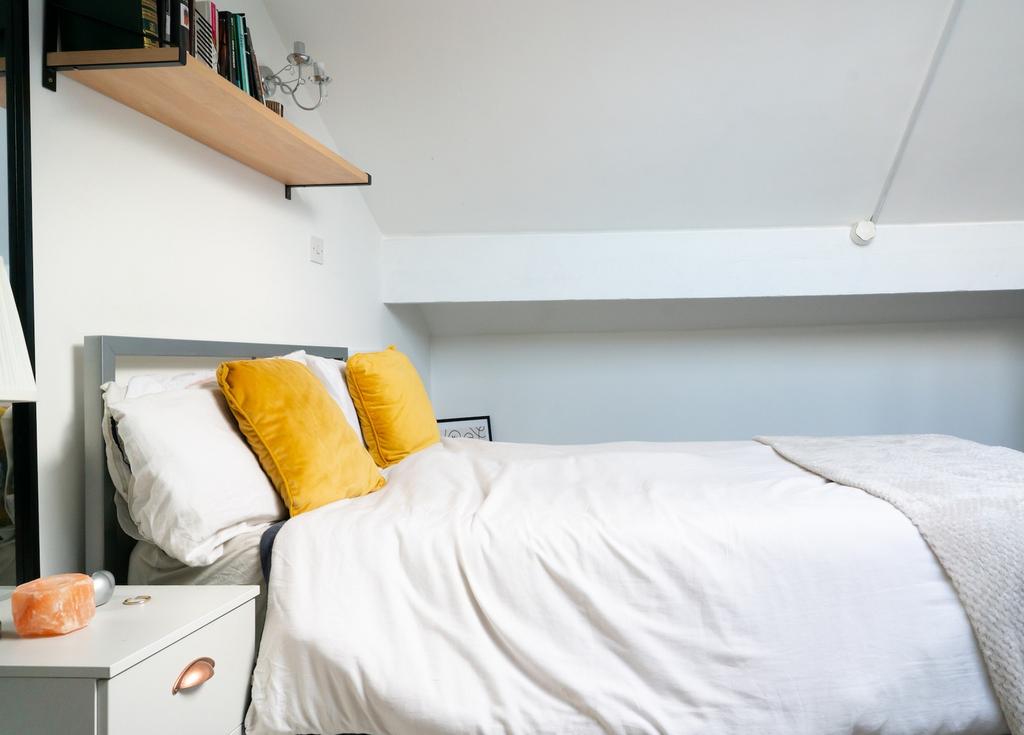 A bright and inviting double bedroom featuring ...