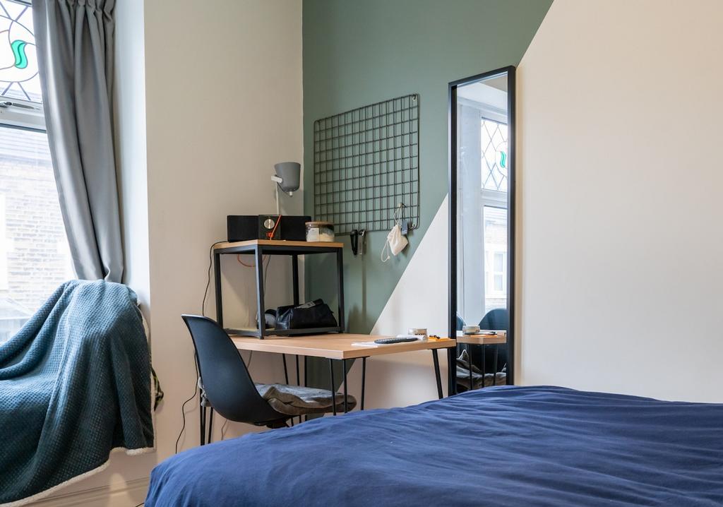 A bright and inviting double bedroom featuring ...
