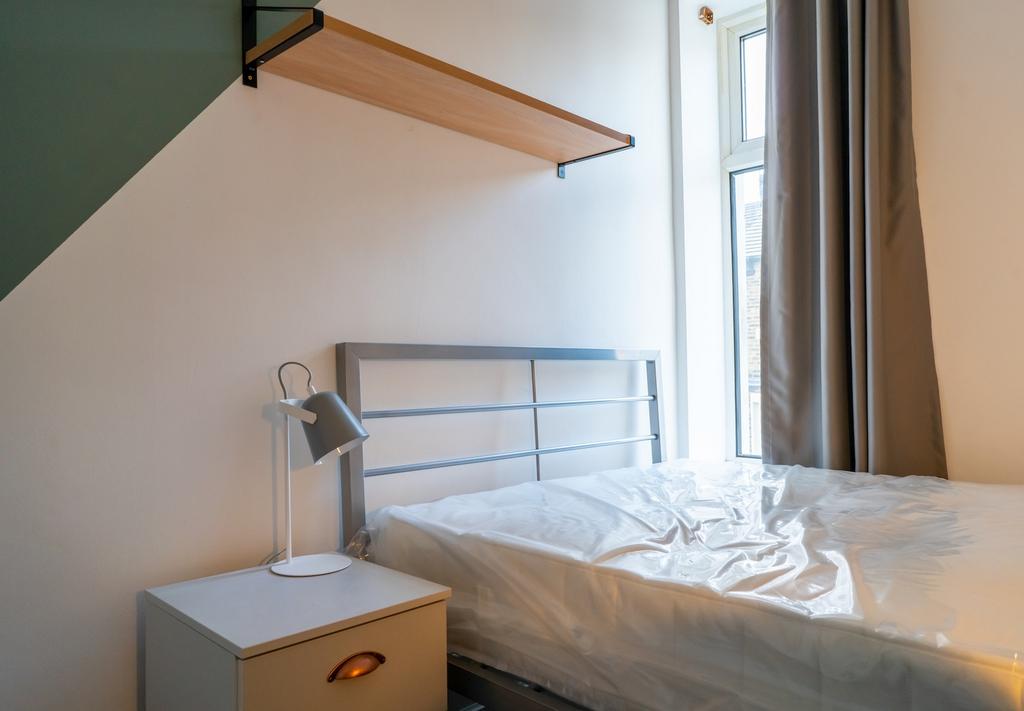 A bright and tidy double bedroom with a modern ...