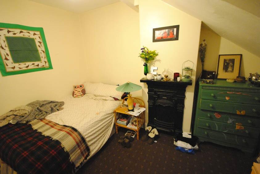 A spacious and cozy master bedroom with a comfo...