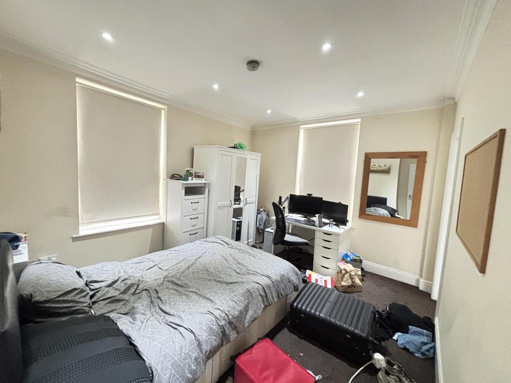 A bright and spacious living room featuring lar...