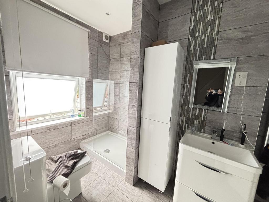 A clean and modern bathroom featuring a spaciou...