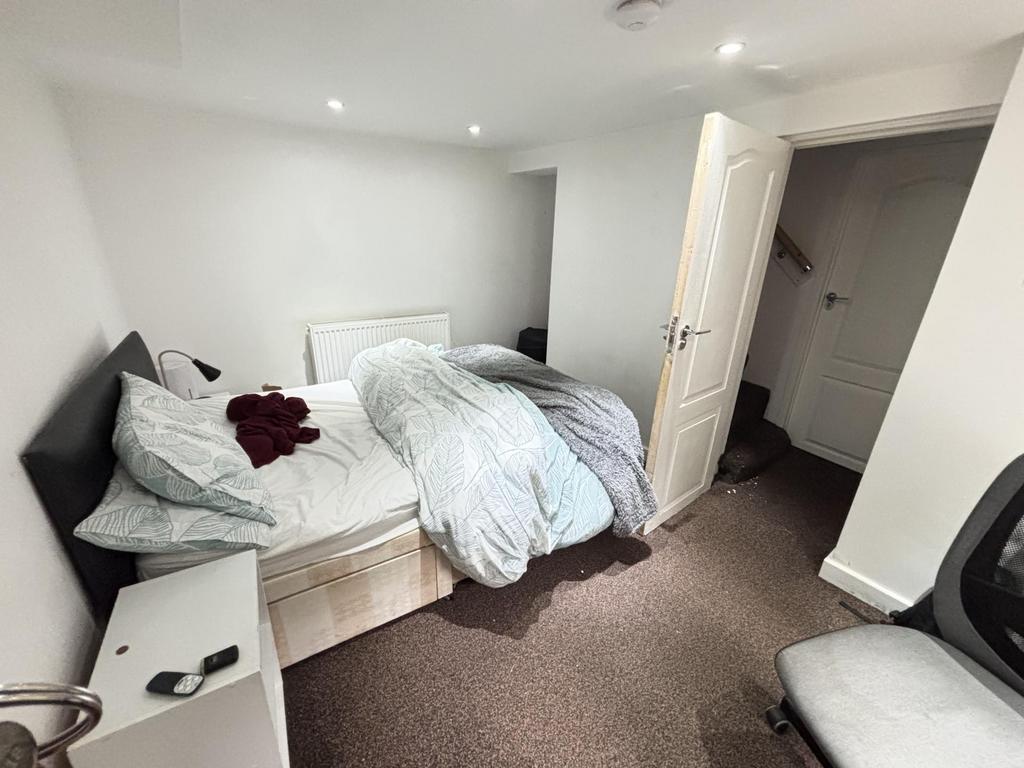 A spacious, well-lit master bedroom featuring a...