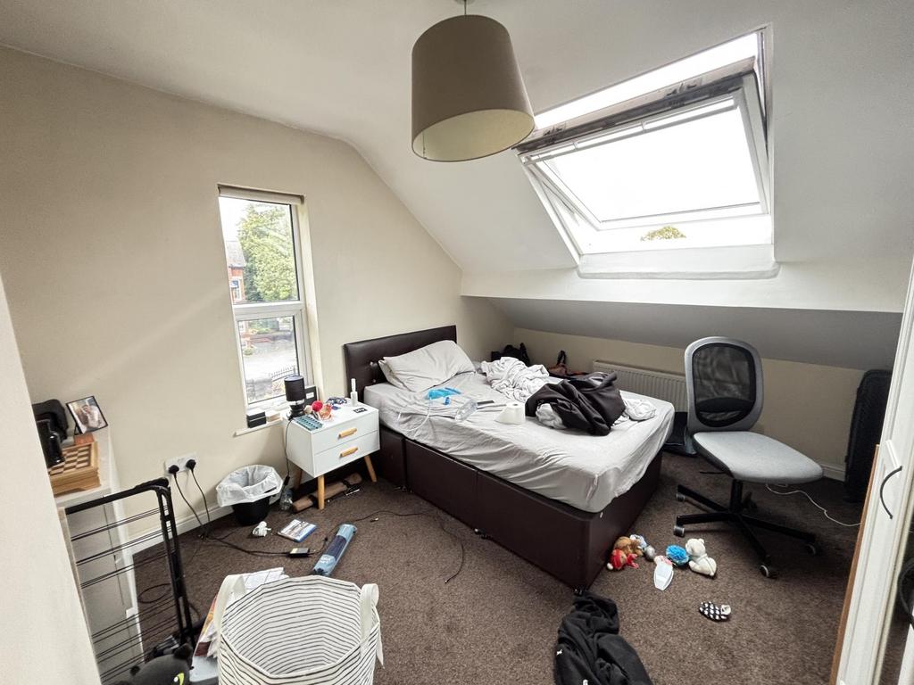 A spacious master bedroom with a large double b...