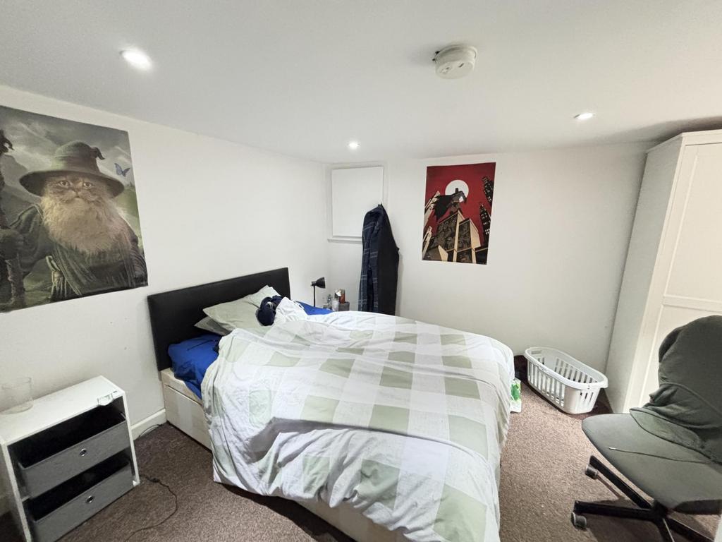 A bright and tidy bedroom with a large bed, mod...