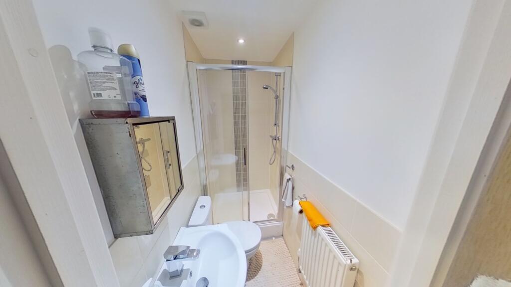 Bright, modern bathroom with a walk-in shower, ...