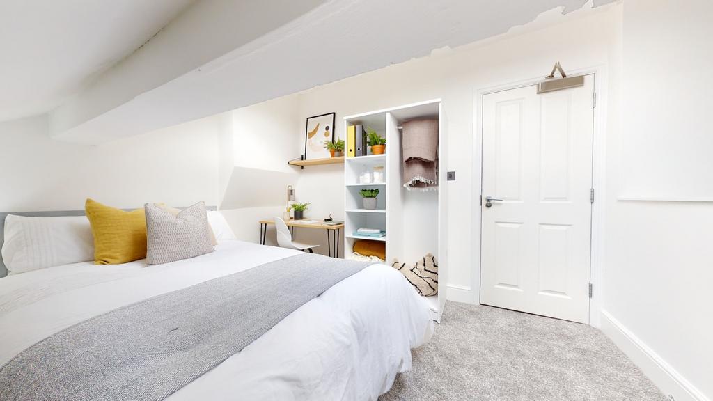 A bright and spacious double bedroom featuring ...