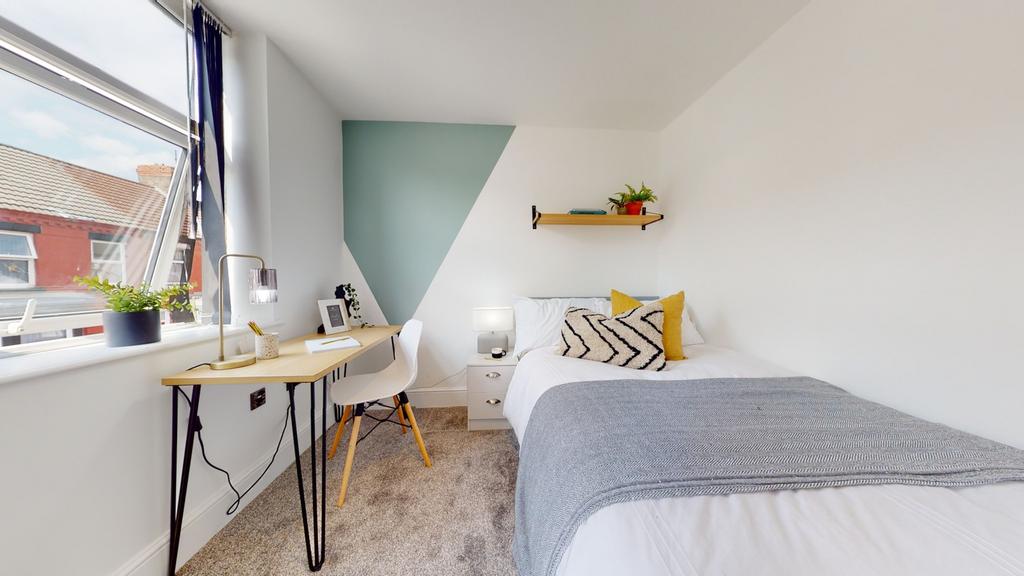 A bright and stylish double bedroom featuring a...