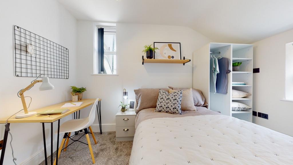 A stylish and well-lit double bedroom featuring...