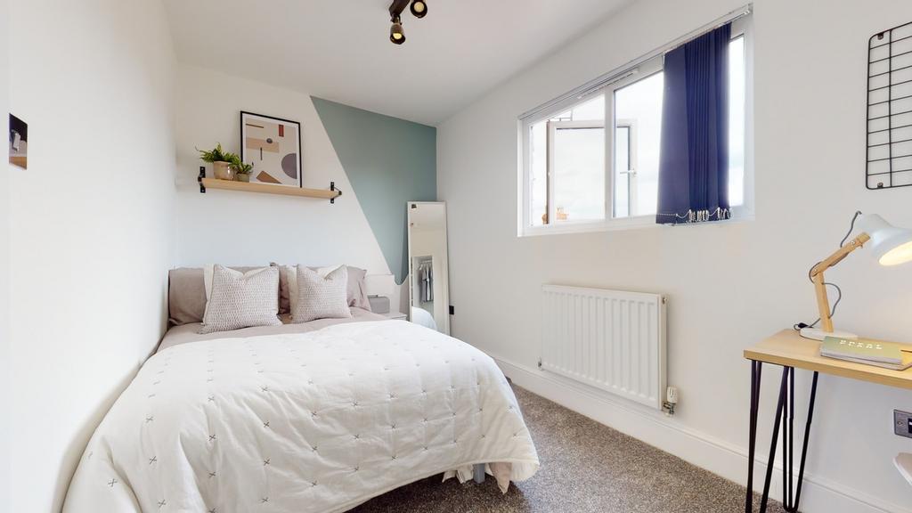 A bright and inviting double bedroom featuring ...