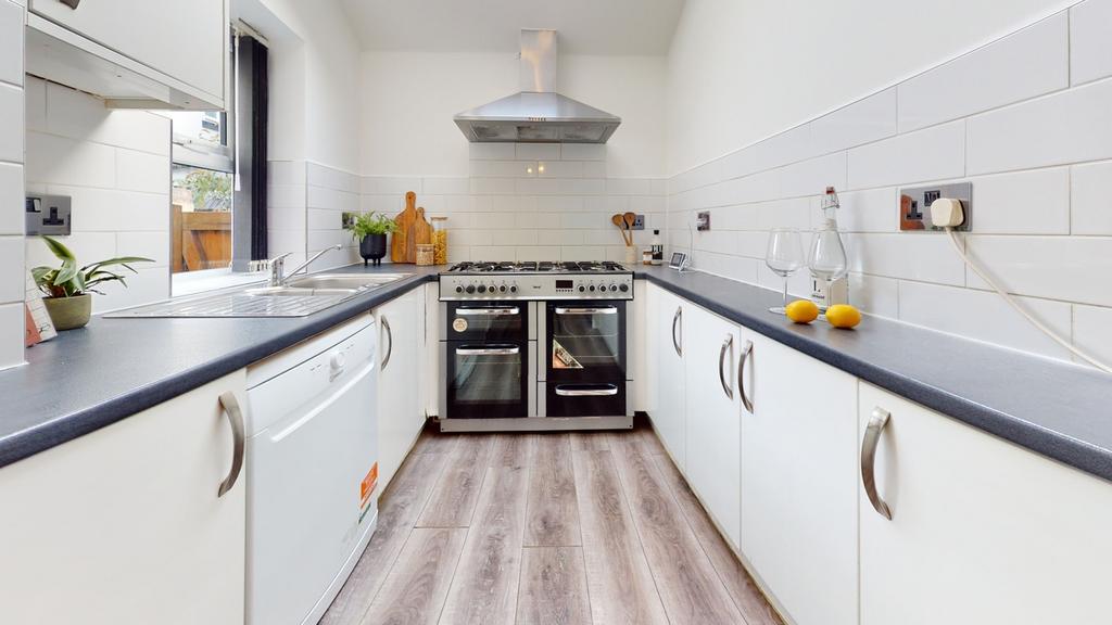 A bright and modern kitchen featuring sleek cab...