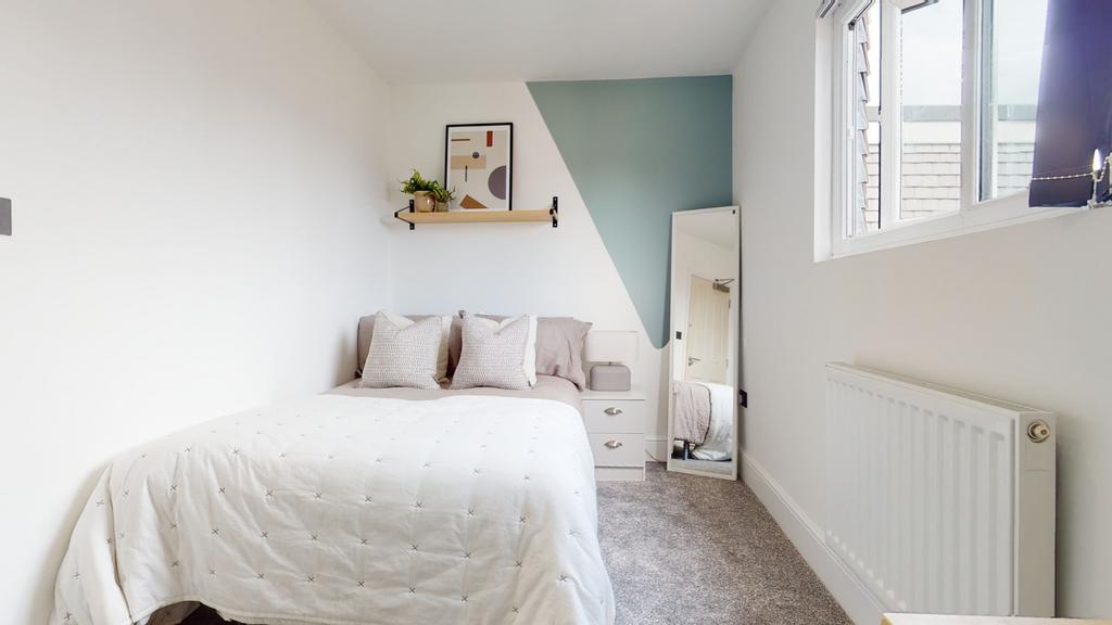 A bright and inviting double bedroom featuring ...