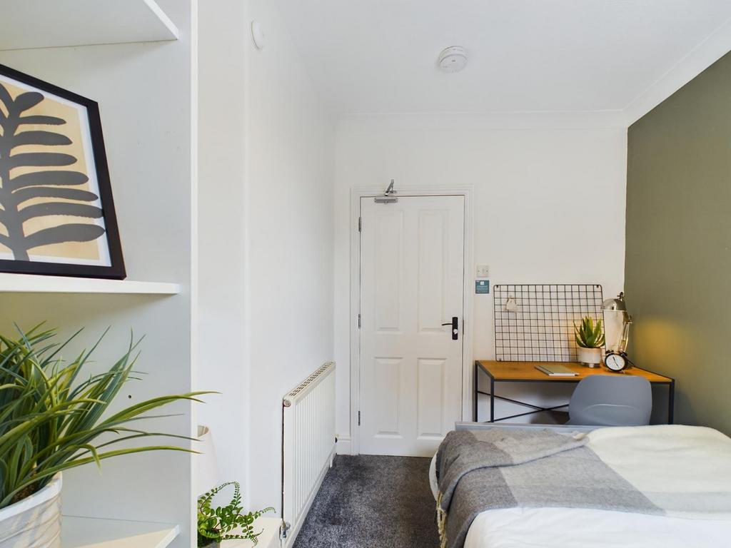A bright and inviting double bedroom with moder...