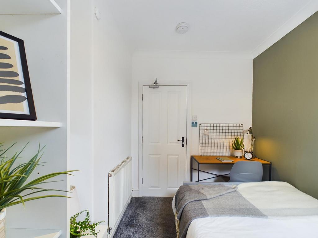 A bright and inviting double bedroom featuring ...