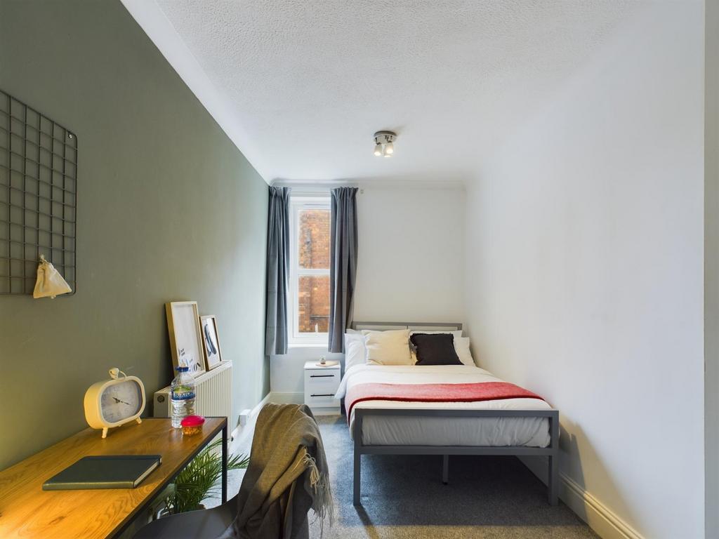 A bright and inviting double bedroom featuring ...