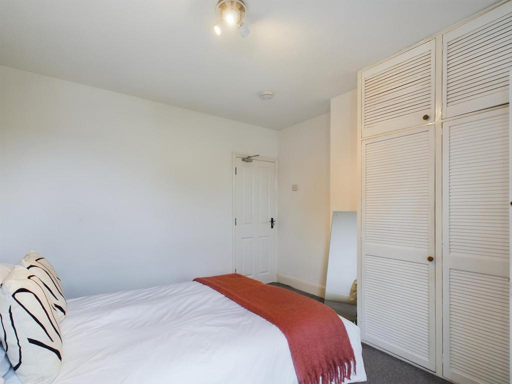 A bright and inviting double bedroom featuring ...