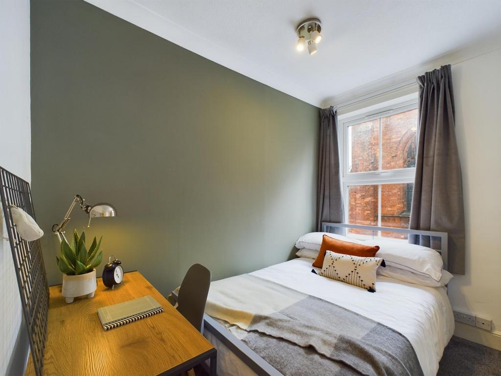 A cozy and well-lit double bedroom, perfect for...