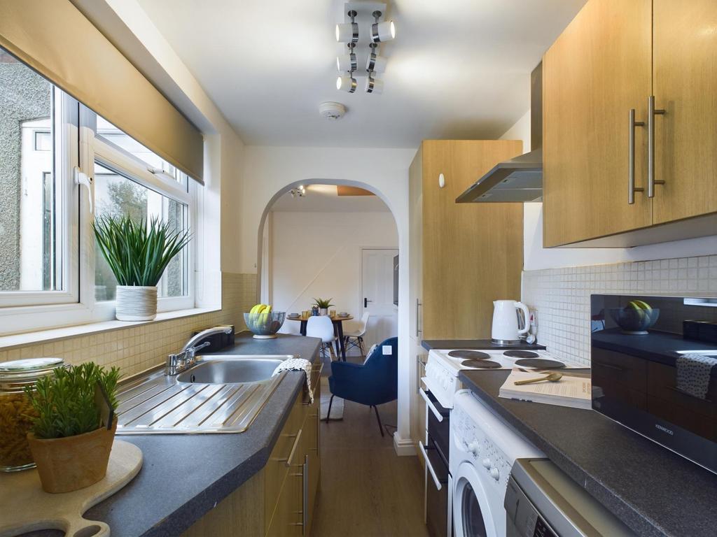 A modern and clean kitchenette with ample natur...