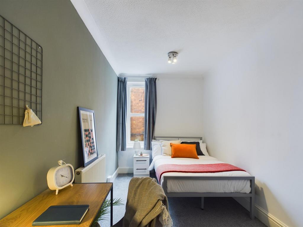 A stylish and well-lit double bedroom featuring...