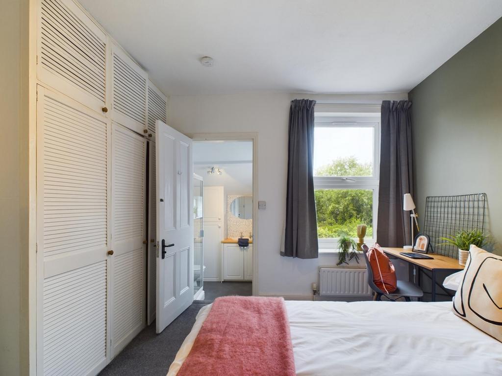 A bright and inviting double bedroom featuring ...