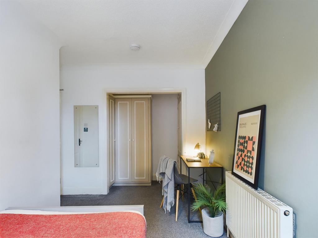 A cozy and well-maintained double bedroom, feat...