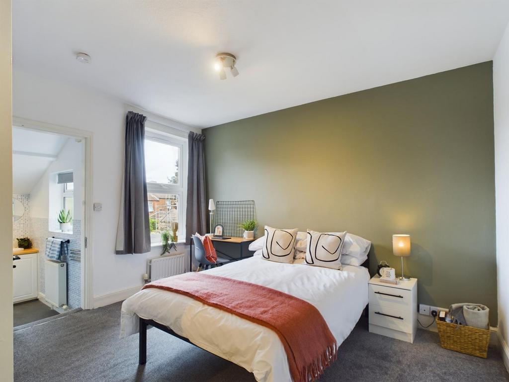A spacious and well-lit double bedroom featurin...