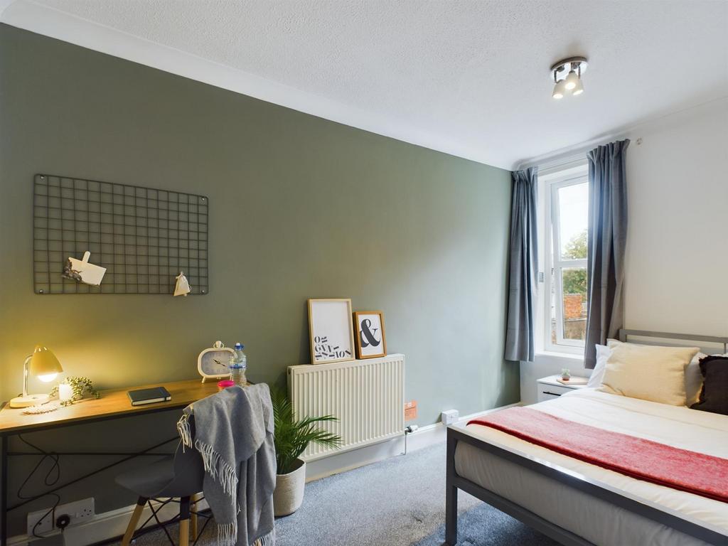 A bright and inviting double bedroom with a mod...