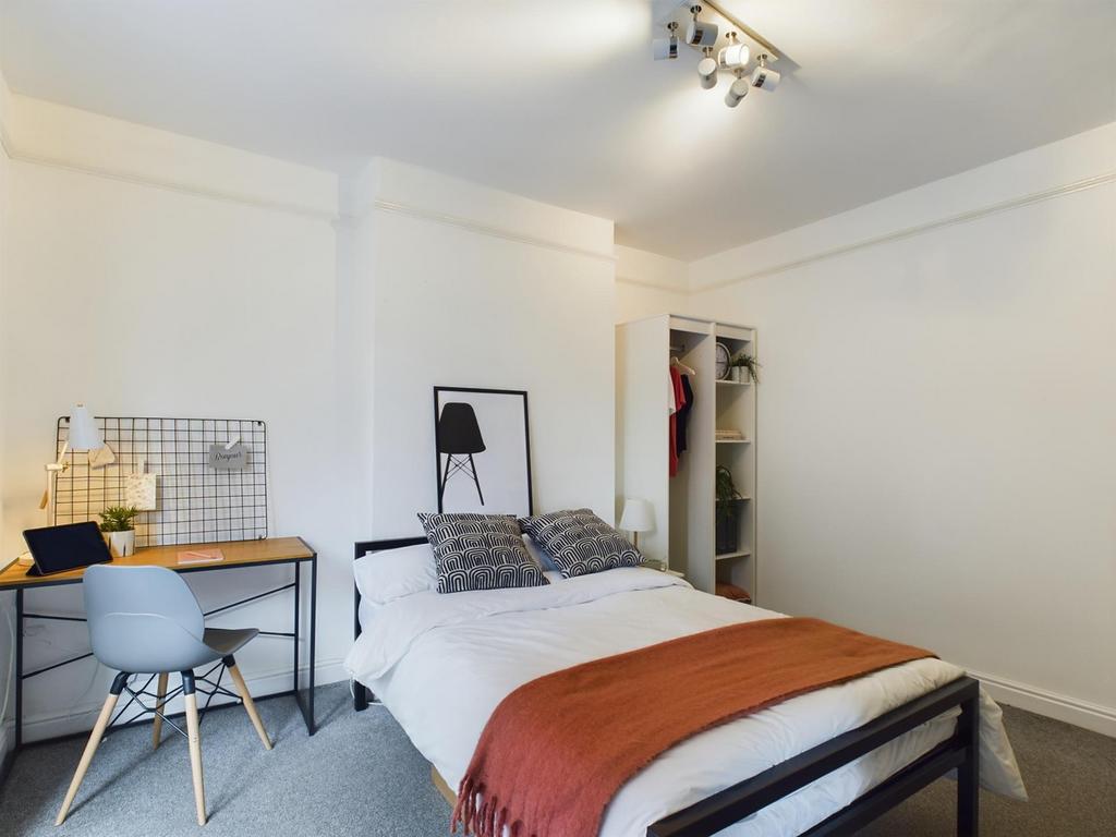A spacious and bright double bedroom featuring ...
