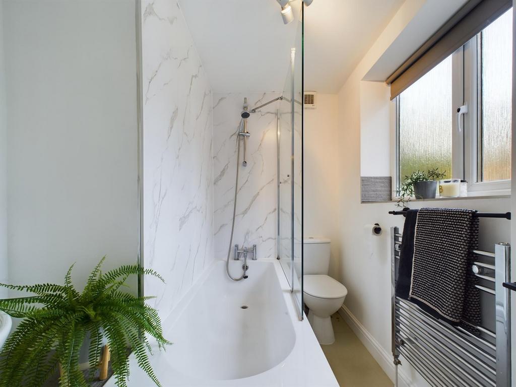 A bright and modern bathroom featuring a relaxi...