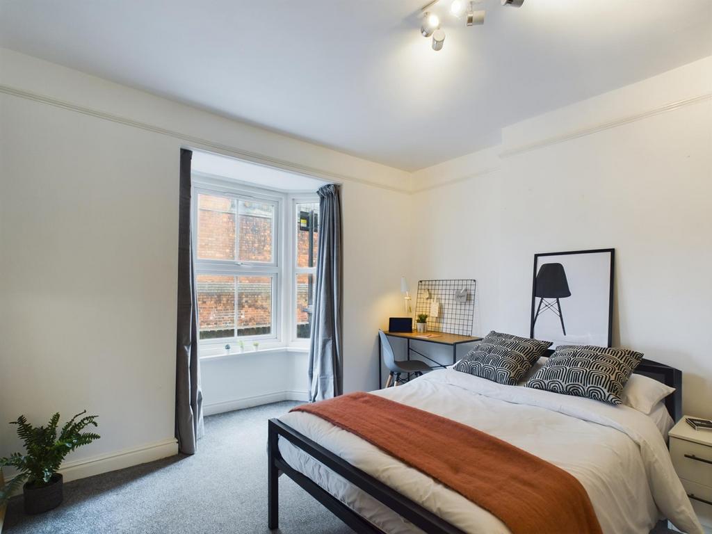 A bright and inviting double bedroom featuring ...