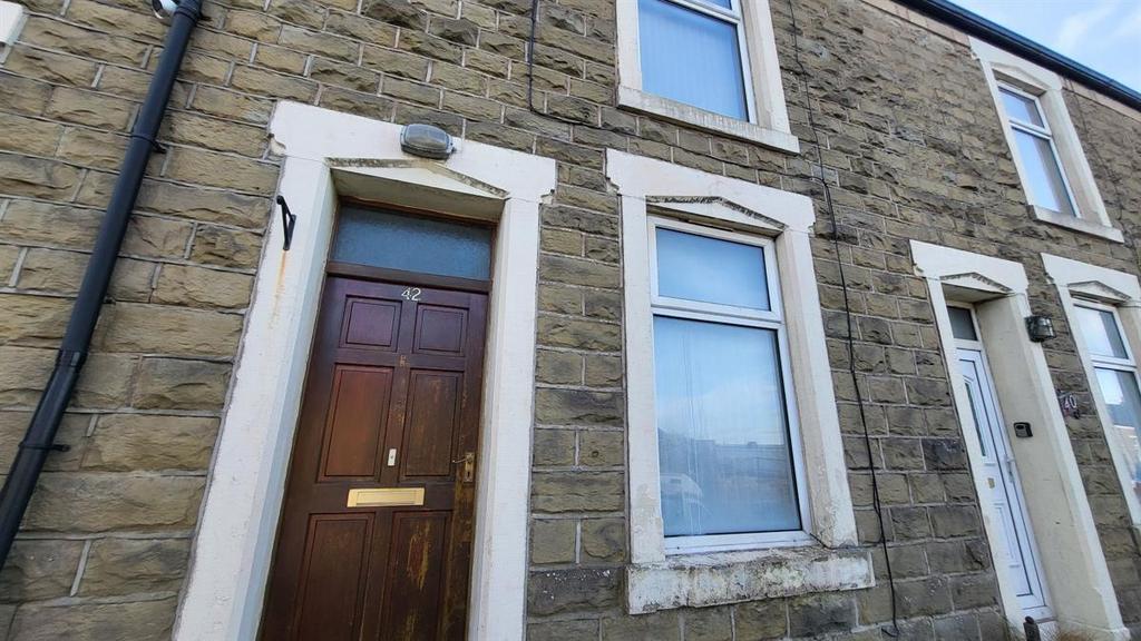 Stone-fronted terraced house with traditional w...