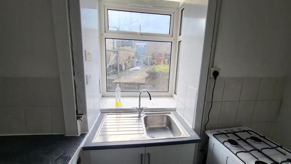 Compact kitchen with a stainless-steel sink and...