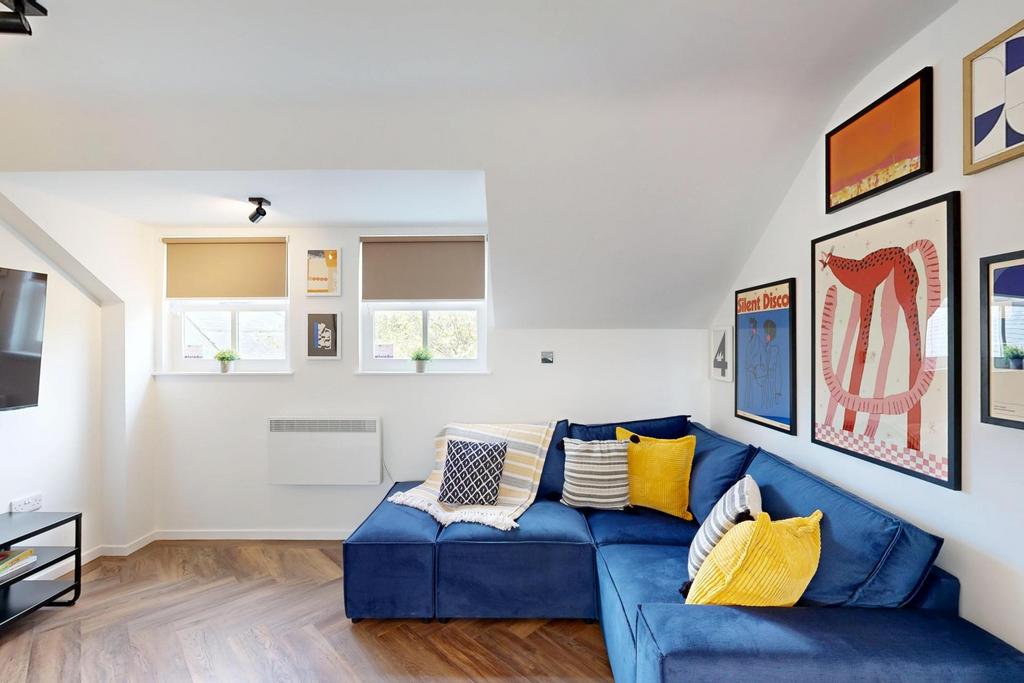 Bright, stylish living room with a blue section...