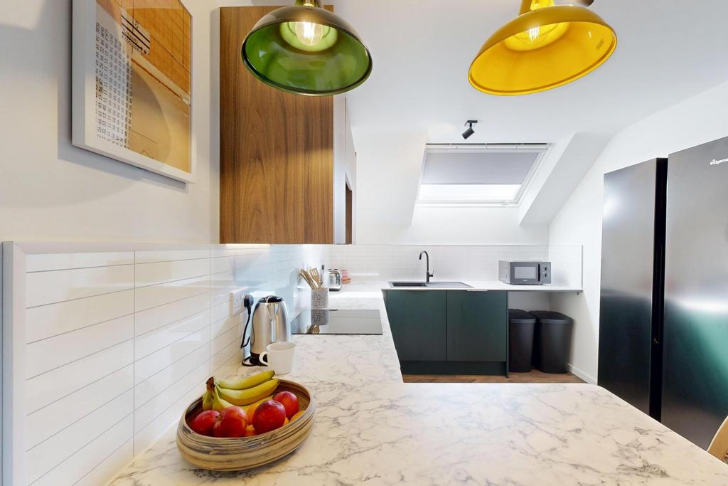 Bright modern kitchen with sleek countertops, c...