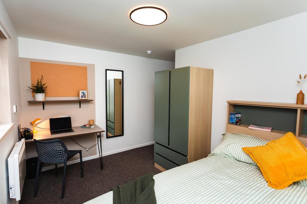 Bright, neatly arranged bedroom with a double b...