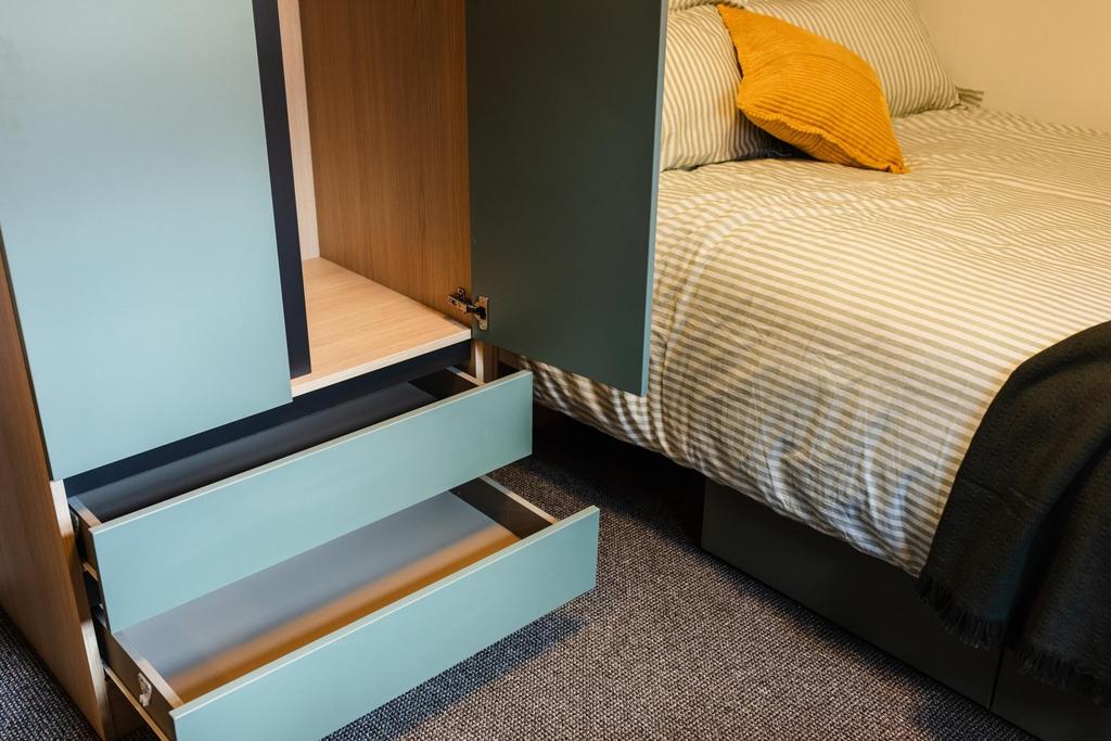 Cozy bedroom corner with a neatly made single b...