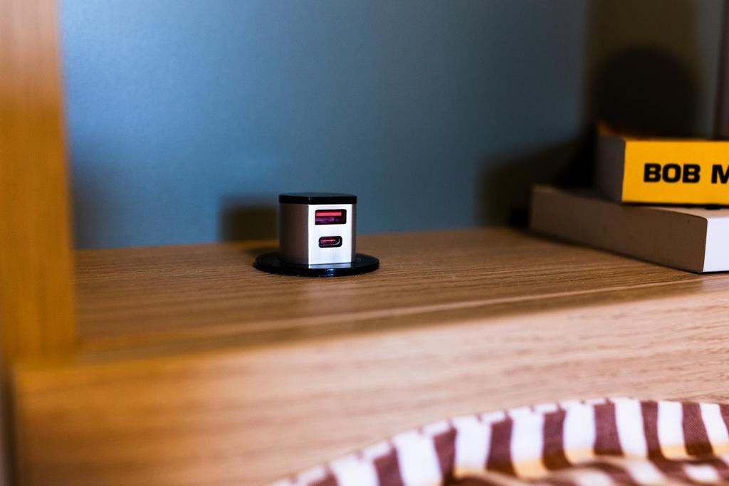 Cozy bedside shelf with neat wood finish, featu...