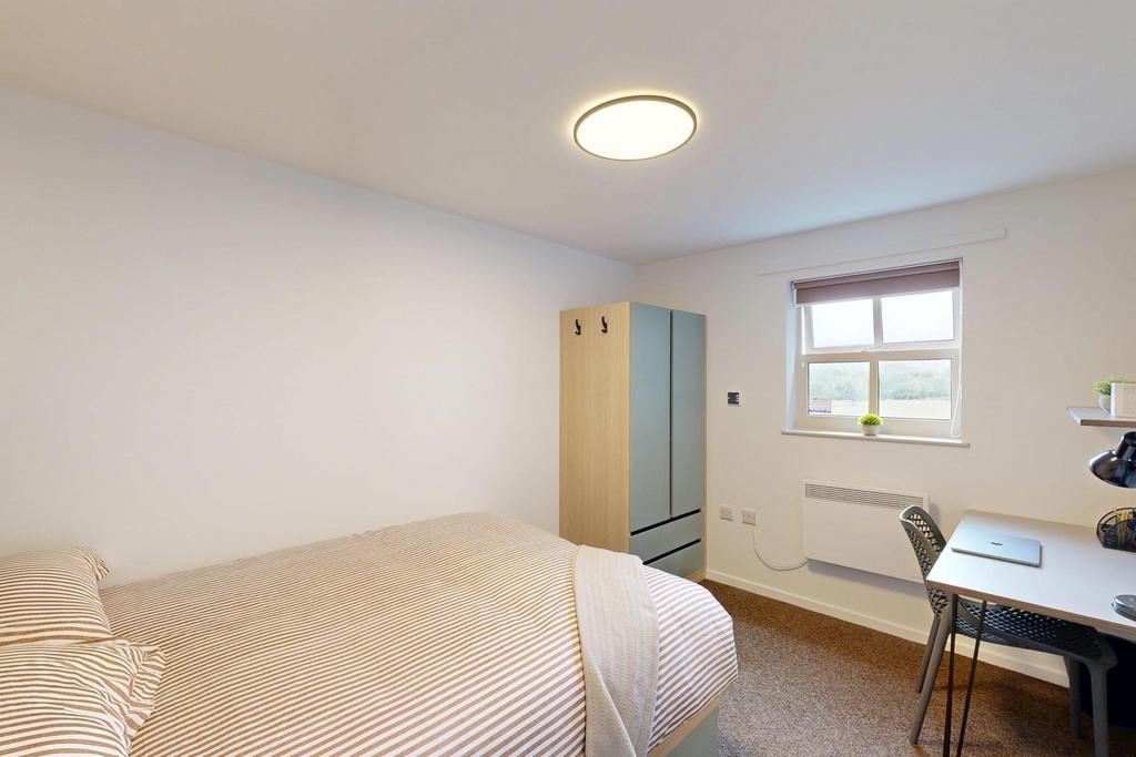 Bright, simply furnished double bedroom with a ...