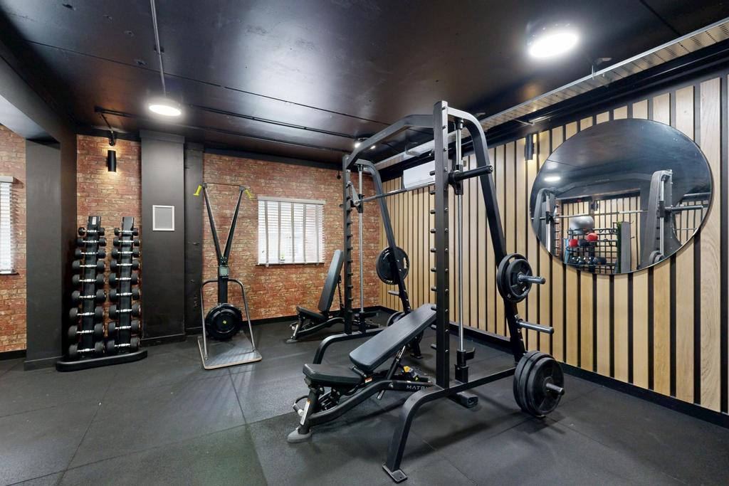 Well-equipped private gym with weight station, ...