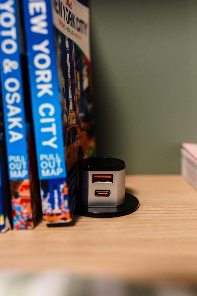 Neat wooden shelf corner styled with travel gui...