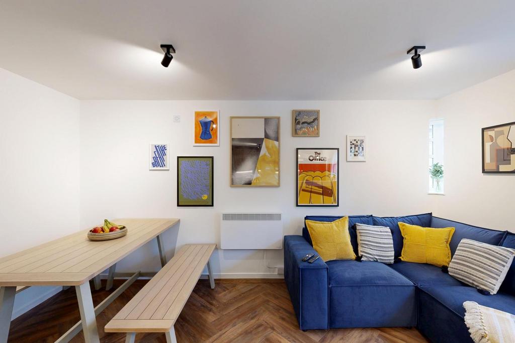 Bright, modern living area with a comfortable b...