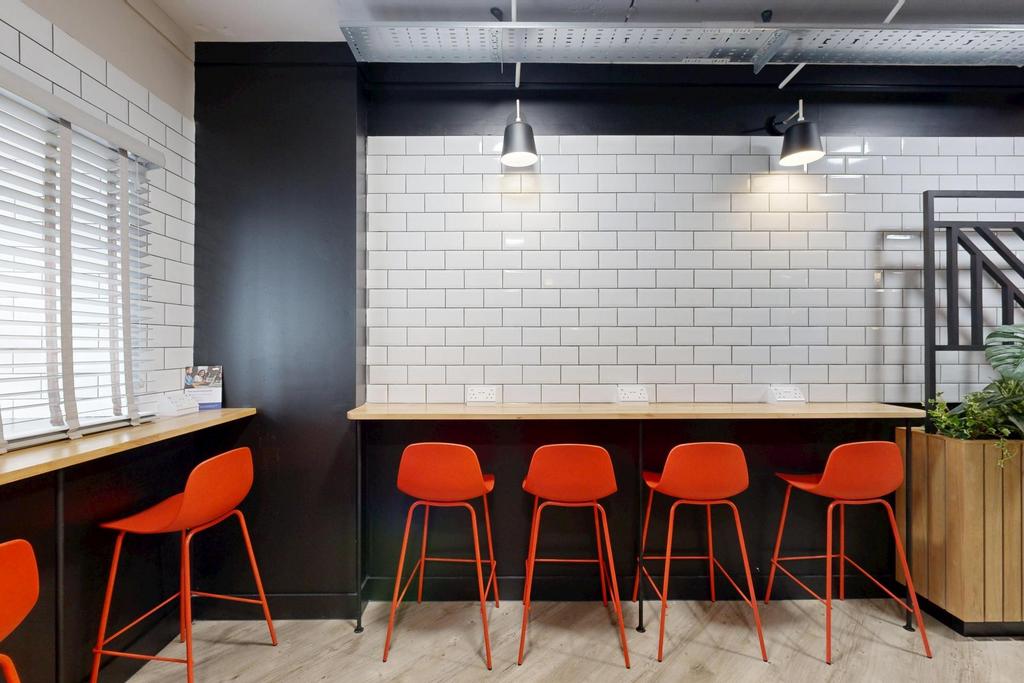 Bright, modern communal workspace with a long b...